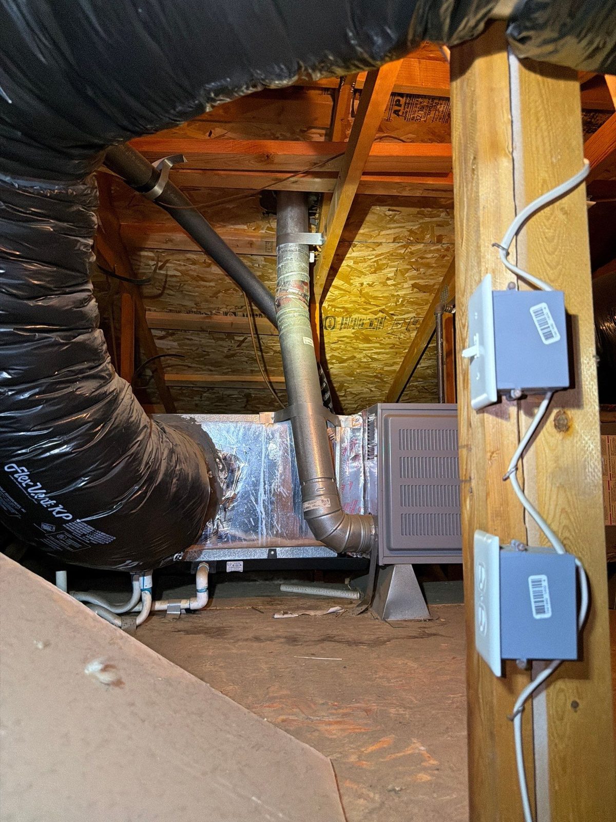 Residential attic framing with rafters, ducting and junction boxes