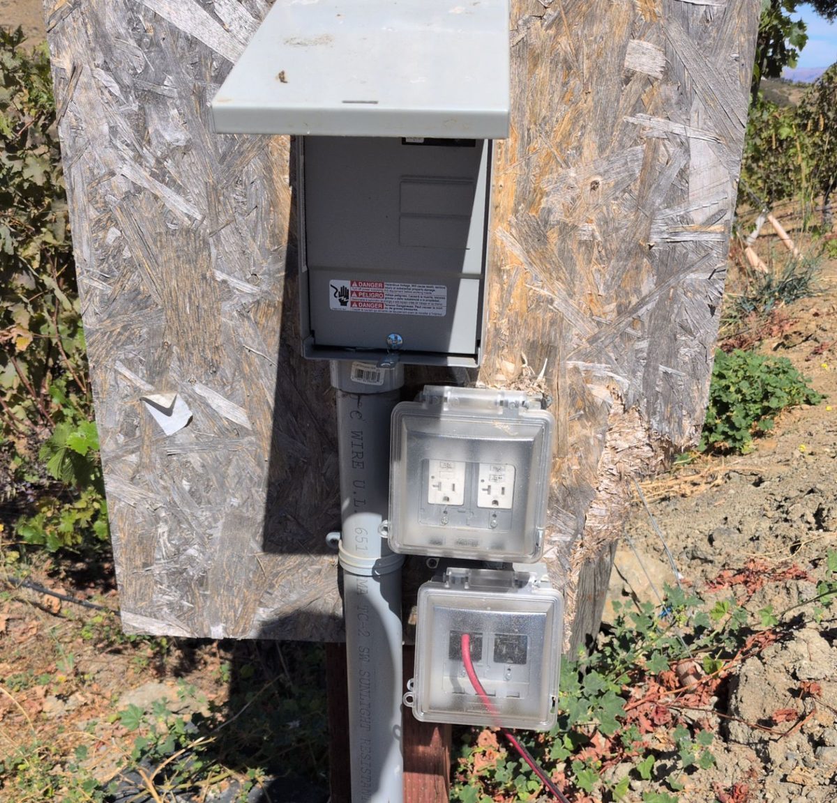 Outdoor electrical pedestal on a post with a covered disconnect enclosure, conduit and weatherproof receptacles